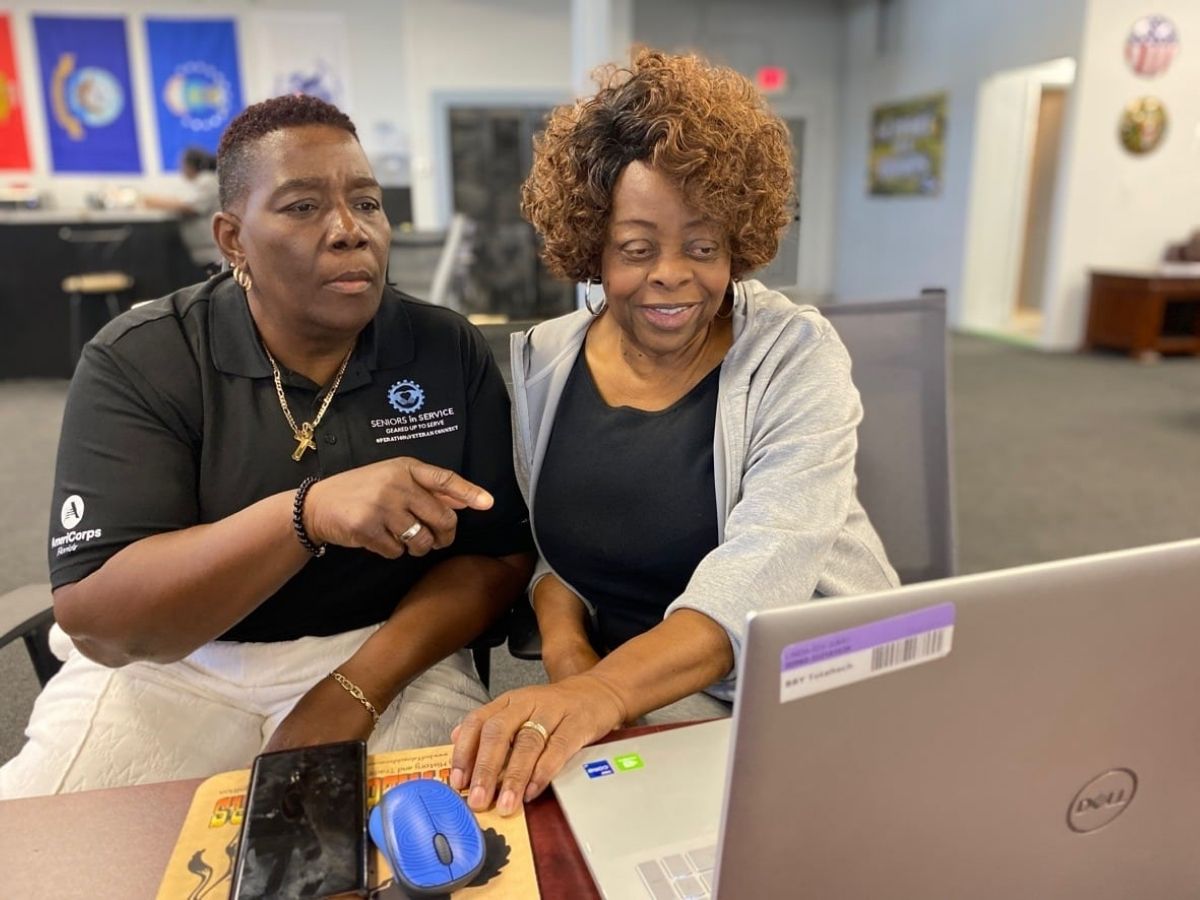 Operation: Veteran Connect volunteer helps a veteran learn how to access VA benefits and health information online.