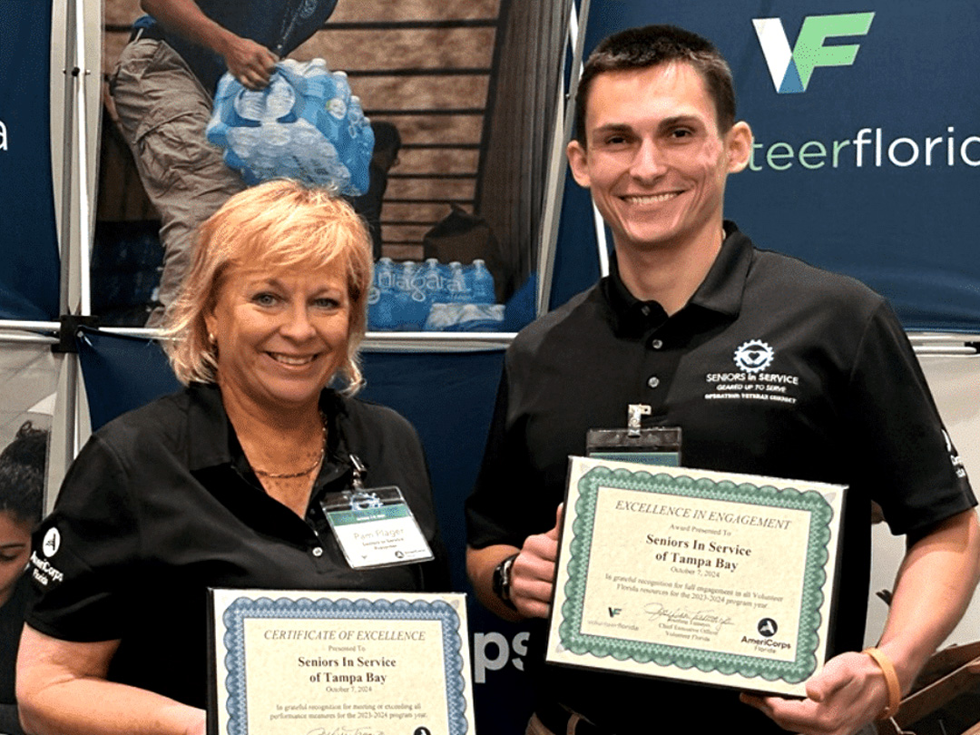 Seniors in Service team members display Volunteer Florida awards recognizing excellence in volunteer engagement and community impact.