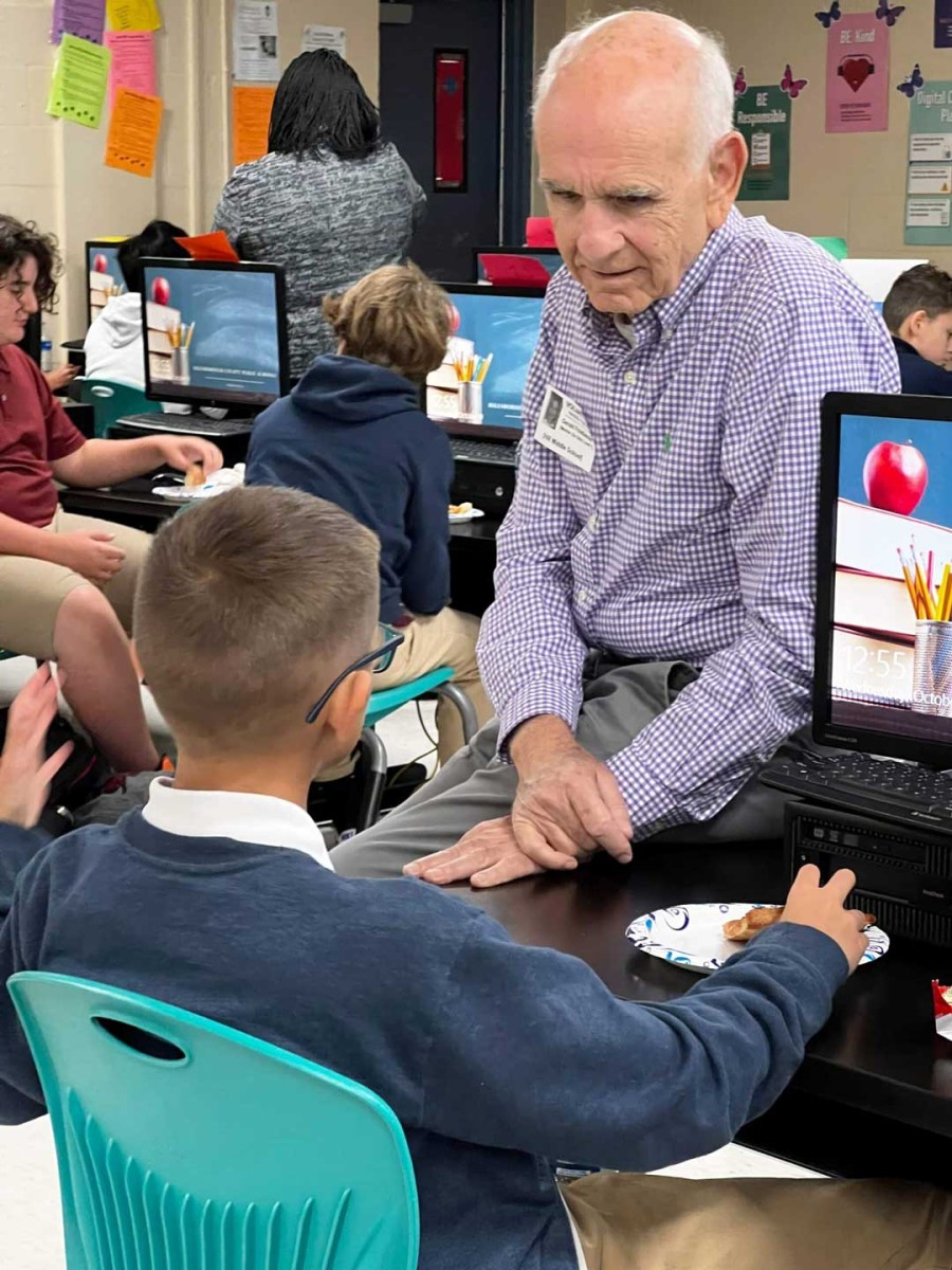 A volunteer mentor speaks one-on-one with a middle school student during a mentoring session at Ben Hill Middle School in Tampa.